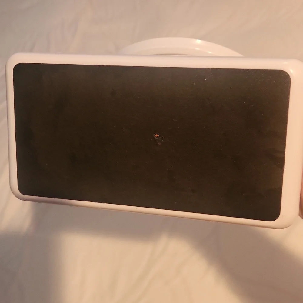 White double-sided vanity mirror with one side magnified.